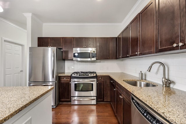 kitchen with backsplash, ornamental molding, dark wood-style flooring, stainless steel appliances, and a sink