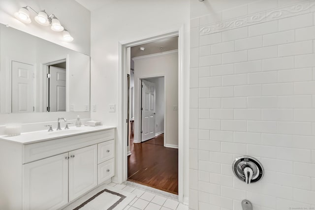 bathroom with tile patterned floors, vanity, crown molding, and baseboards