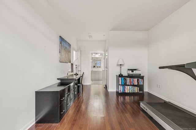 hall with baseboards and hardwood / wood-style flooring