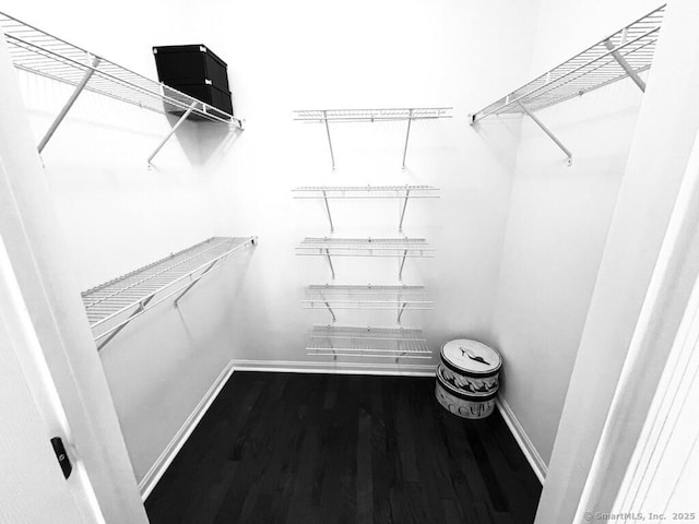 spacious closet with wood finished floors