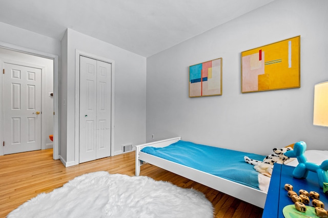 bedroom featuring hardwood / wood-style floors and a closet