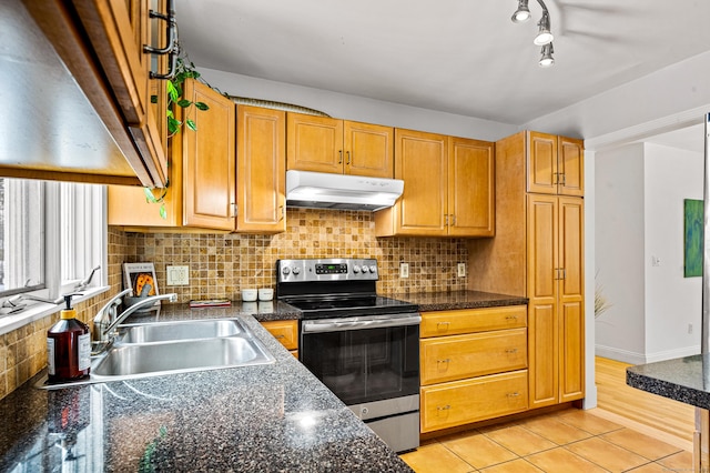 kitchen with sink, backsplash, light tile patterned floors, and stainless steel electric range oven