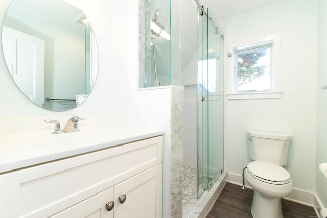 bathroom with vanity, hardwood / wood-style floors, an enclosed shower, and toilet