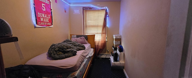 bedroom with carpet flooring and a baseboard radiator