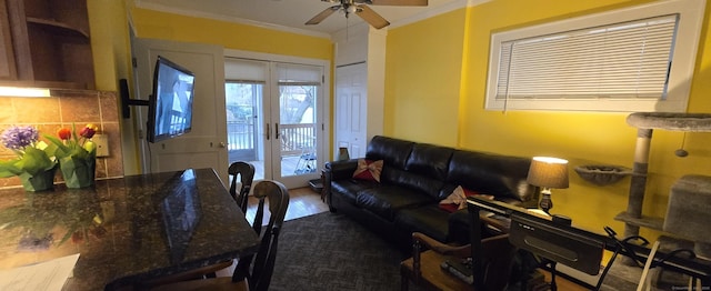 living room featuring ceiling fan, dark wood-type flooring, crown molding, and french doors