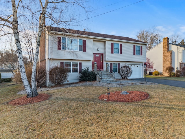 raised ranch with a front yard and a garage