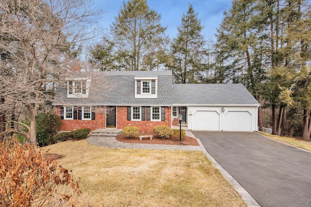 new england style home with a garage and a front lawn