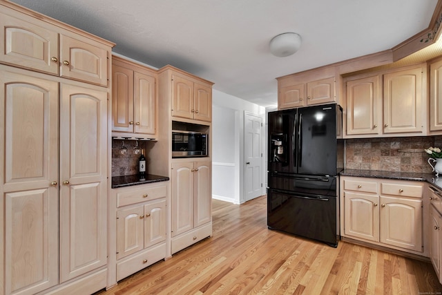 kitchen featuring tasteful backsplash, built in microwave, black fridge with ice dispenser, and light brown cabinets