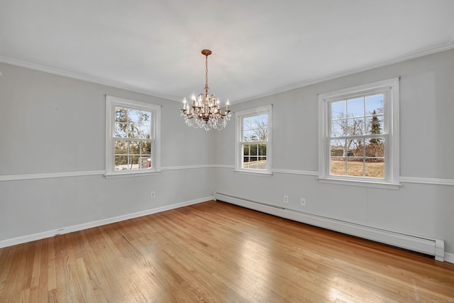 spare room with light hardwood / wood-style floors, ornamental molding, baseboard heating, and a chandelier