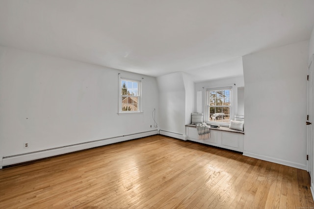 spare room featuring light wood-type flooring and a baseboard radiator