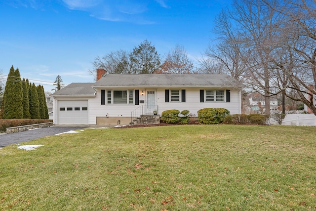 ranch-style house featuring a front lawn and a garage