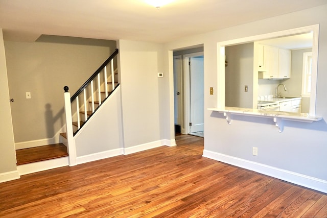 unfurnished room with light hardwood / wood-style flooring and sink