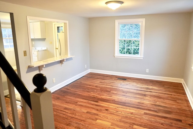 unfurnished room with hardwood / wood-style floors