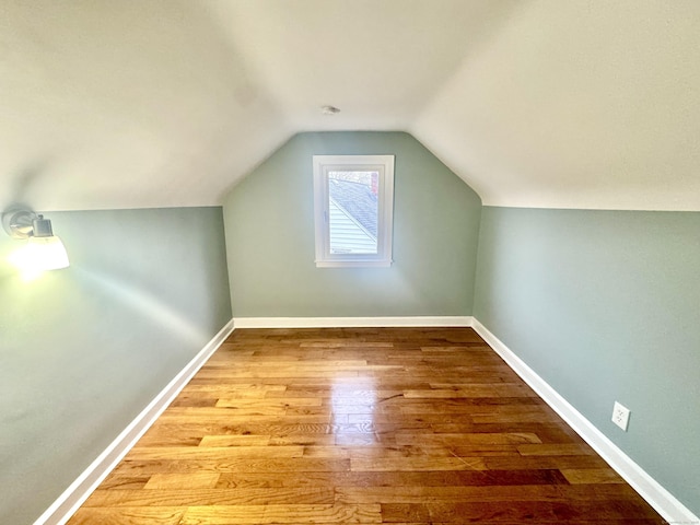 bonus room featuring light hardwood / wood-style flooring and lofted ceiling