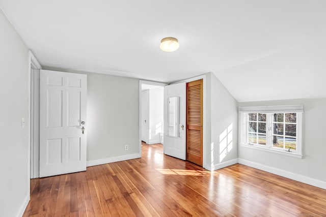 bonus room featuring wood-type flooring and lofted ceiling