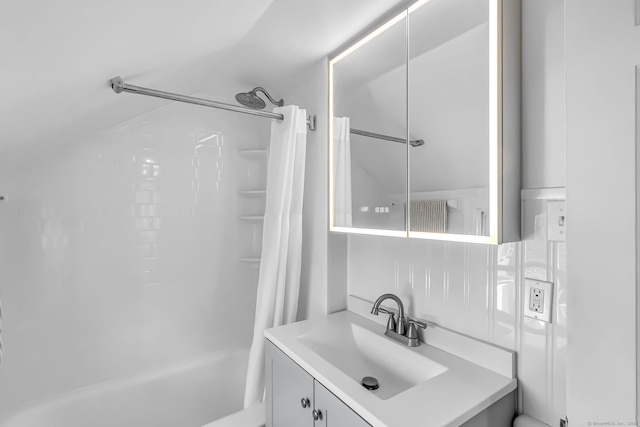 bathroom with shower / tub combo with curtain and vanity