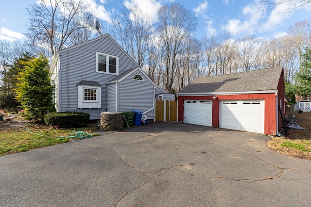 view of side of home with an outdoor structure and a garage