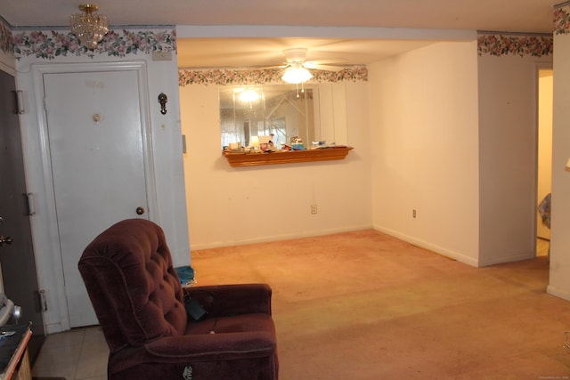 living area featuring carpet flooring and ceiling fan