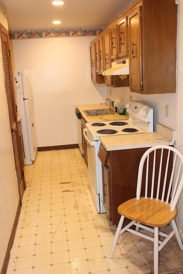 kitchen featuring white appliances and sink