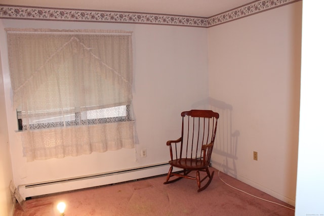 living area featuring carpet and a baseboard heating unit