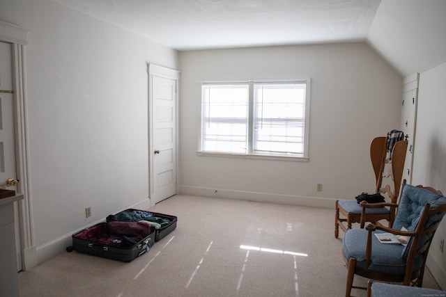 sitting room with lofted ceiling and light carpet