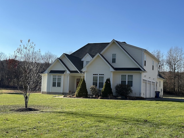 front of property with a front yard and a garage