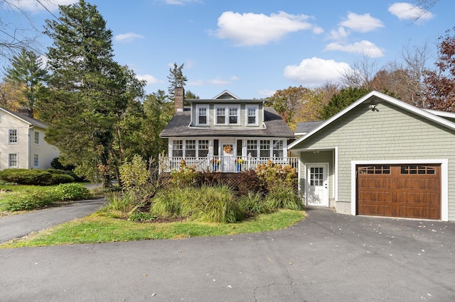 view of front facade featuring covered porch and a garage