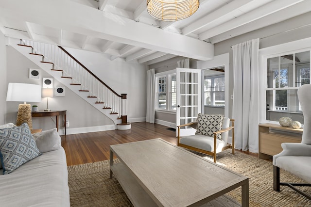 living room featuring beam ceiling and dark hardwood / wood-style floors