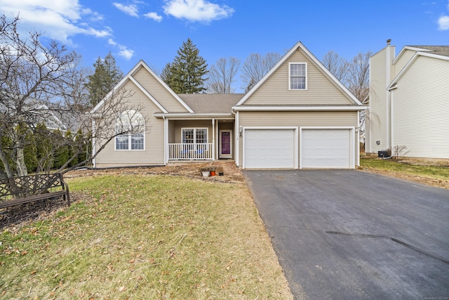 view of front property with a front yard, a porch, a garage, and central AC unit