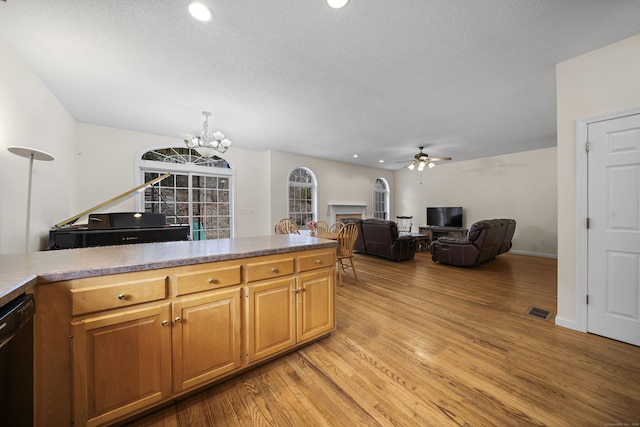 kitchen with a textured ceiling, dishwasher, ceiling fan with notable chandelier, and light hardwood / wood-style flooring