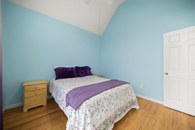 bedroom featuring wood-type flooring, vaulted ceiling, and ceiling fan