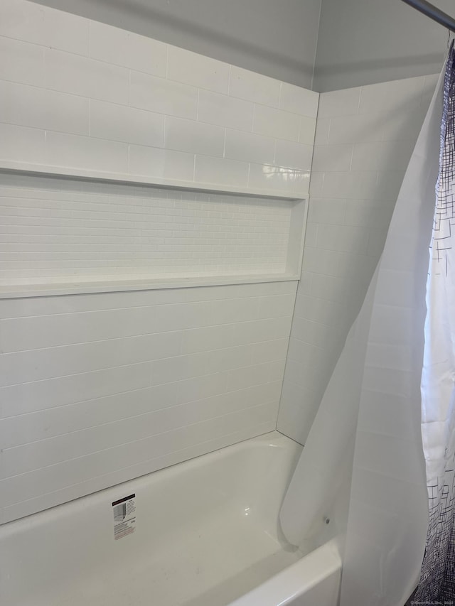 bathroom with shower / bathtub combination with curtain