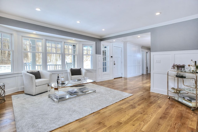 living room featuring wood-type flooring and crown molding