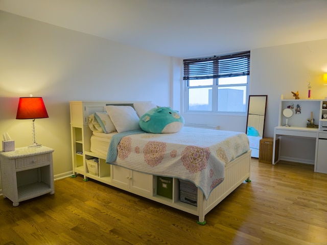 bedroom with wood-type flooring