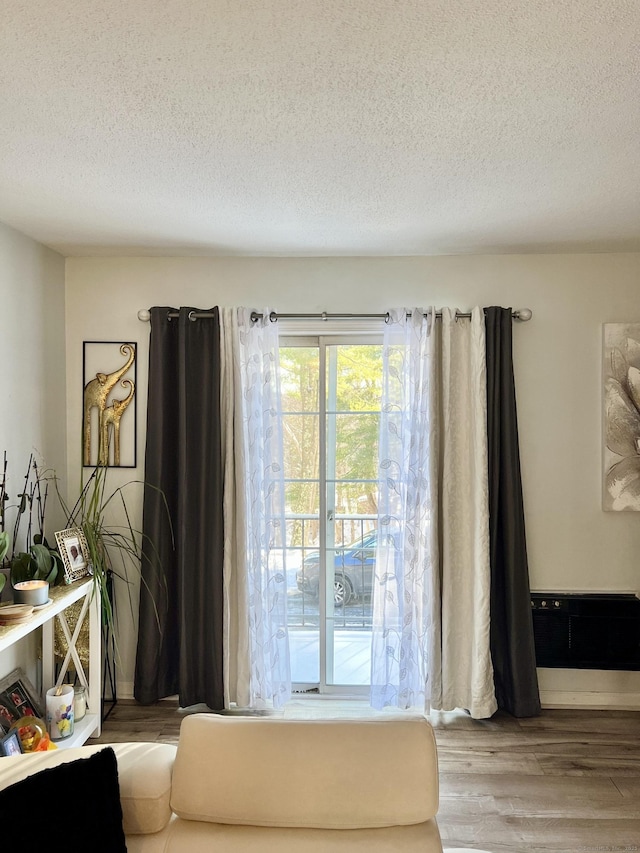 interior space featuring hardwood / wood-style flooring and a textured ceiling