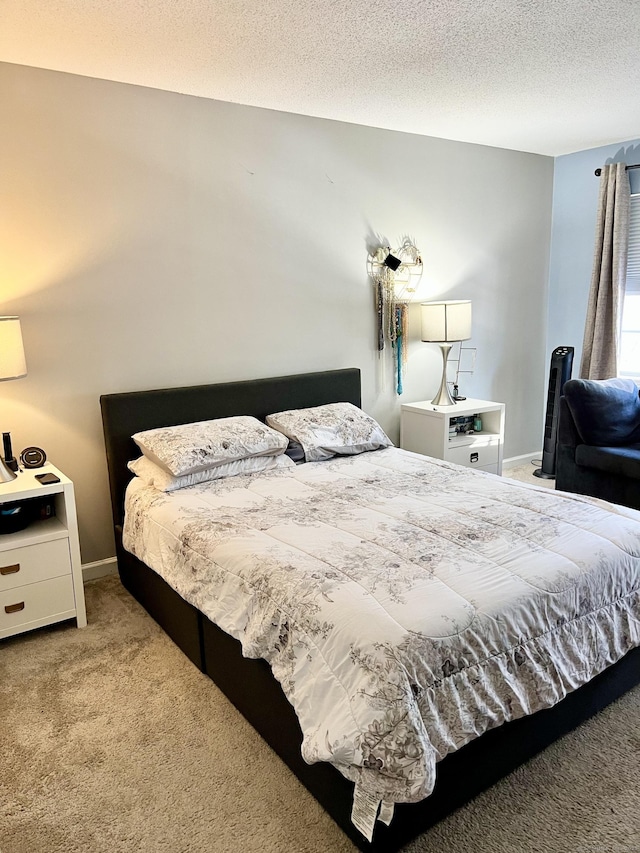 bedroom with light colored carpet and a textured ceiling