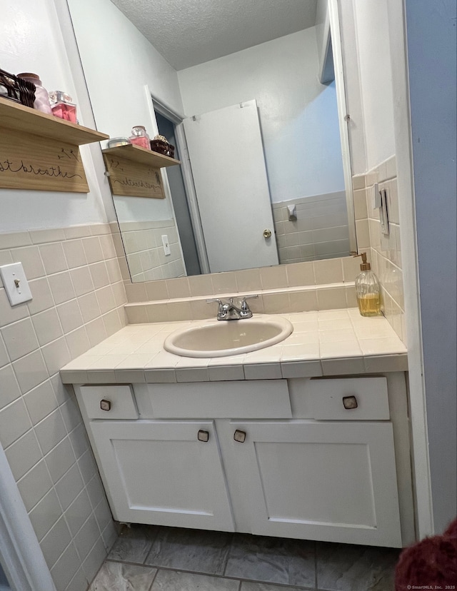 bathroom featuring vanity and a textured ceiling