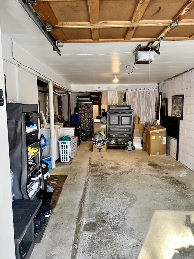 garage featuring separate washer and dryer and a garage door opener