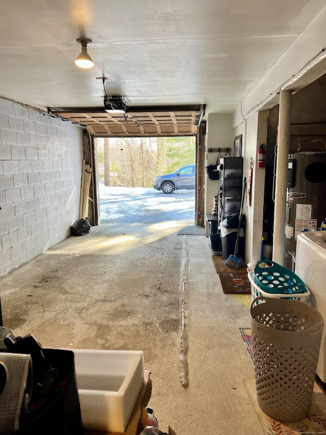 garage featuring a garage door opener and electric water heater