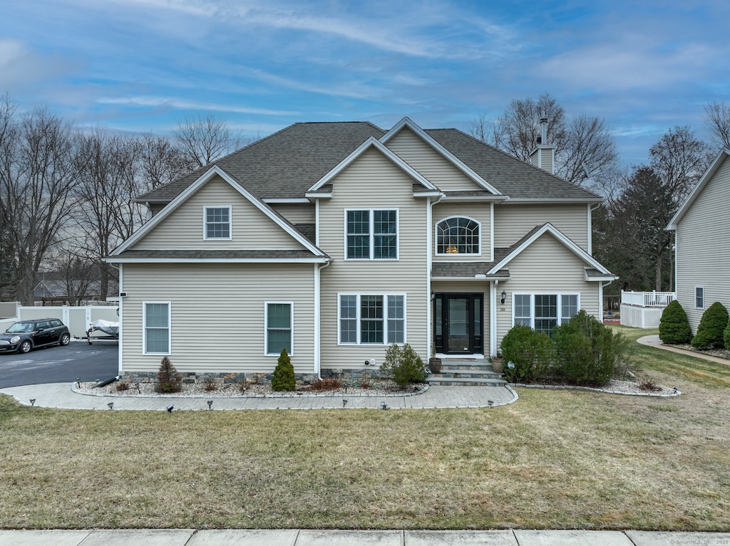 front facade with a front yard