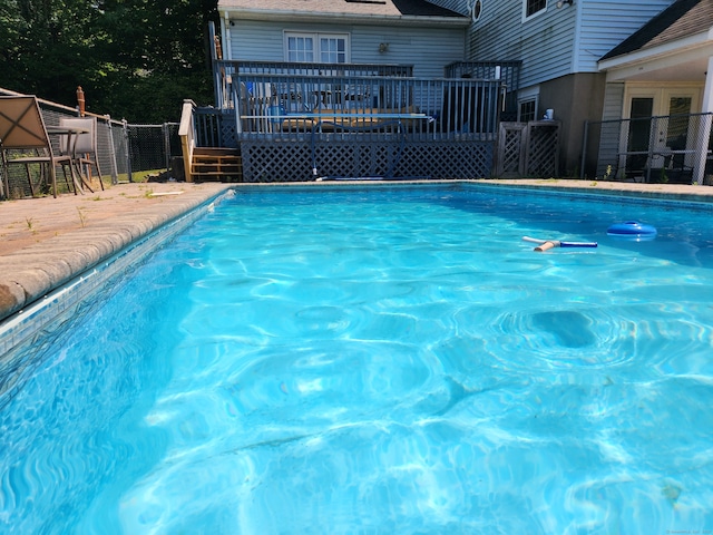 view of swimming pool with a wooden deck