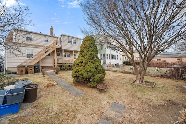 back of property with an outdoor fire pit