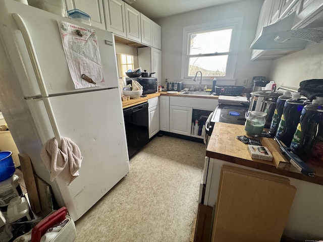 kitchen featuring sink, white cabinets, wooden counters, and black appliances