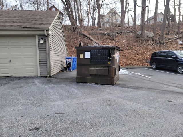 view of car parking featuring a garage