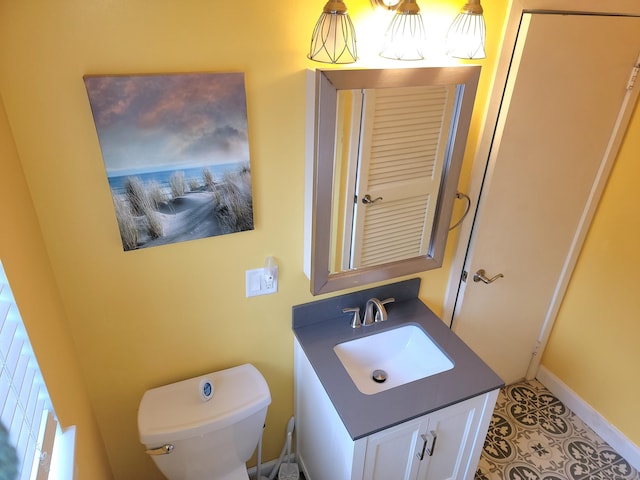 bathroom with tile patterned flooring, vanity, and toilet