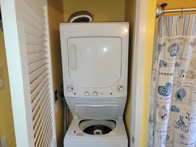 washroom featuring stacked washer and dryer