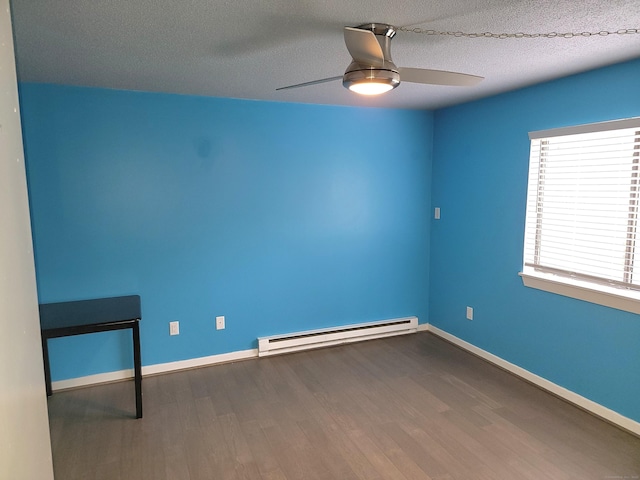 spare room featuring hardwood / wood-style flooring, ceiling fan, a textured ceiling, and a baseboard heating unit