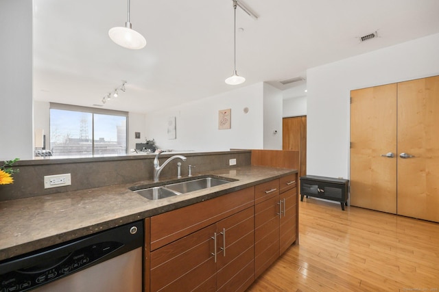 kitchen with sink, hanging light fixtures, light hardwood / wood-style flooring, stainless steel dishwasher, and track lighting