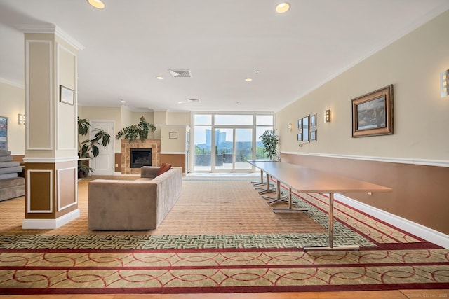 living room featuring floor to ceiling windows and ornamental molding