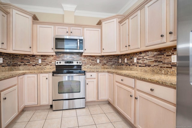 kitchen featuring light tile patterned floors, ornamental molding, tasteful backsplash, light stone counters, and stainless steel appliances